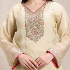 Beige kurta with intricate embroidery on a plain background
