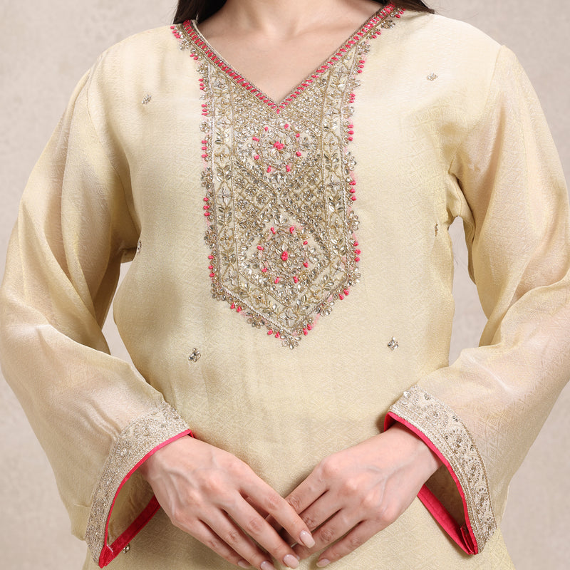 Beige kurta with intricate embroidery on a plain background
