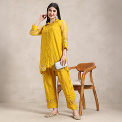 muslin co‑ord set with hand embroidery and net sleeves detail
